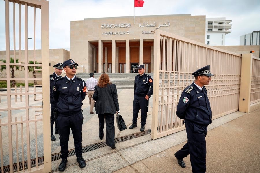 Moroccan policemen stand guard outside the tribunal of Rabat on April 13, 2023, during the trial of three men accused of repeatedly raping an 11-year-old girl. The lawyer for the 11-year-old Moroccan girl from a village near Rabat, raped repeatedly over a period of months and whose rapists received light sentences that outraged the country, urged authorities on April 13 to review laws protecting minors. (Photo by FADEL SENNA / AFP)